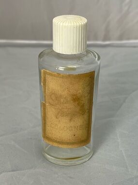 Vintage Shirley Temple Cologne Bottle with White Ribbed Cap and Aged Paper Label